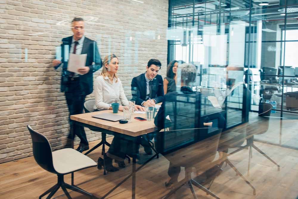 A business meeting in a glass conference room