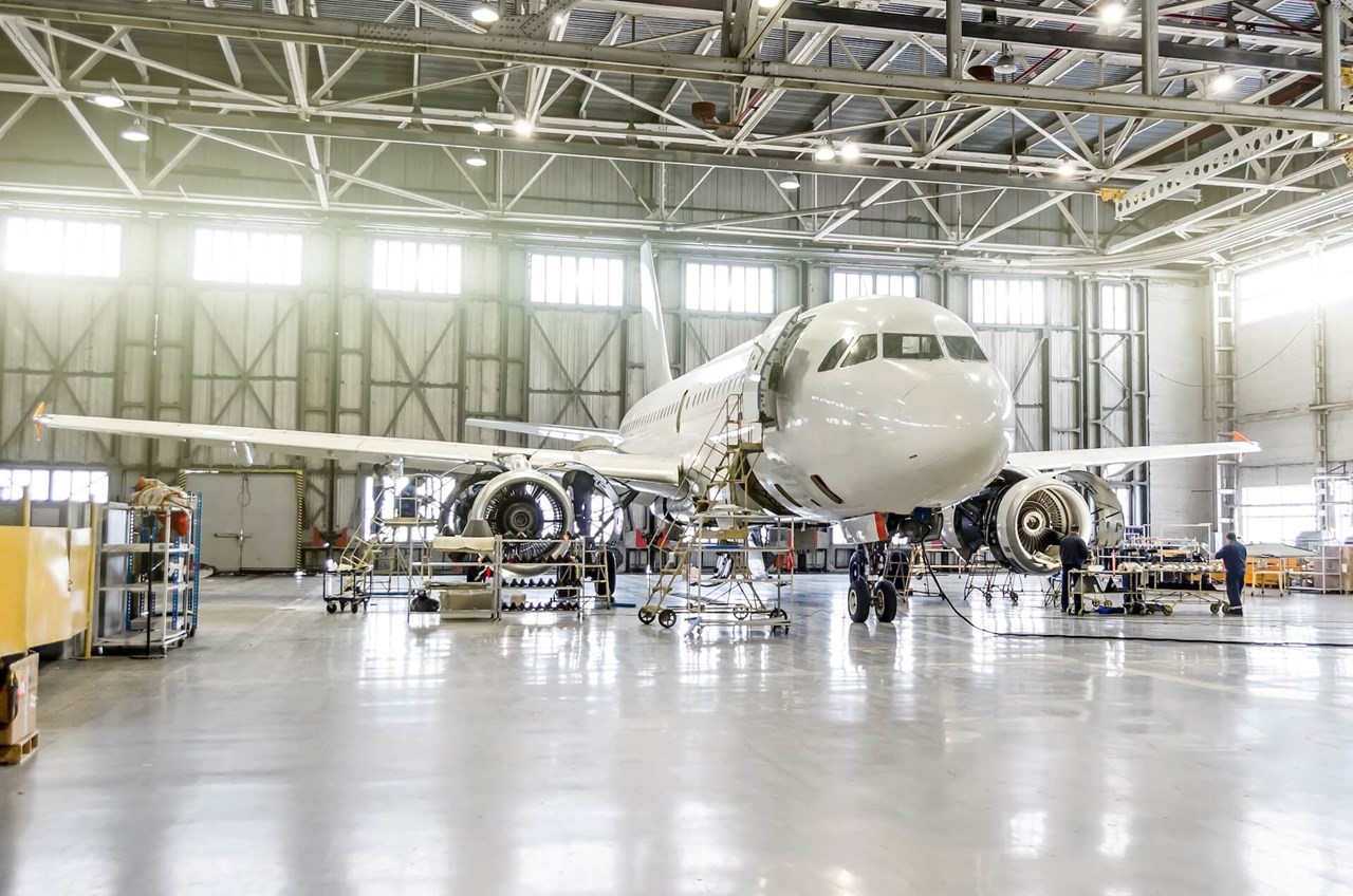 Aircraft undergoing maintenance in a hangar