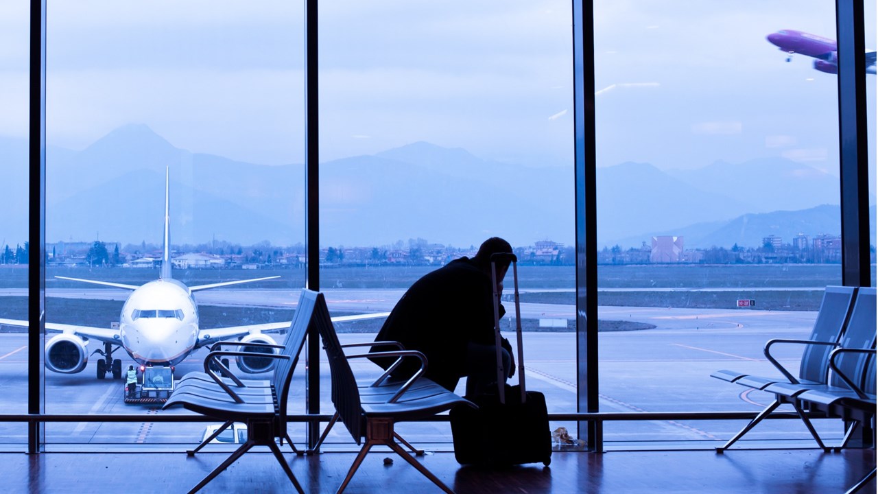 Photo of traveller sitting in an airport terminal